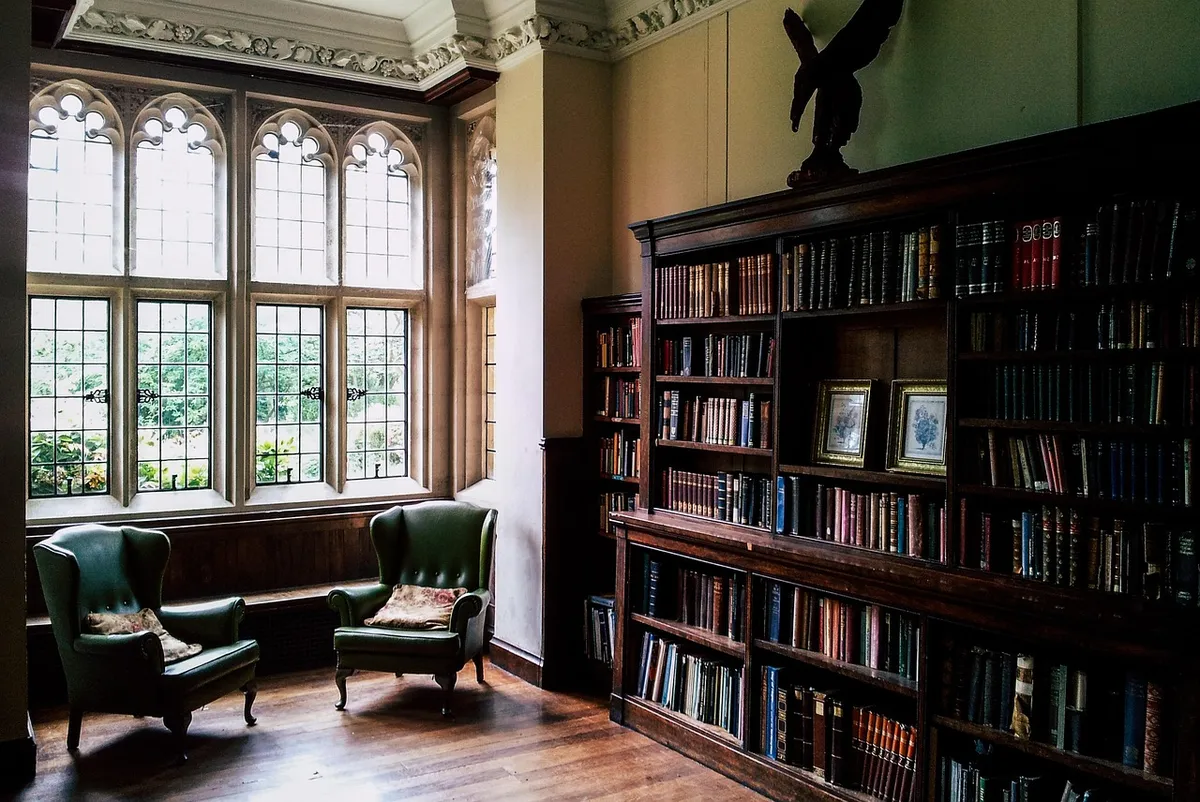 Student nurse in library, studying anatomy textbooks